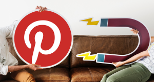 Two people holding a Pinterest logo and a magnet cutout, symbolizing Pinterest’s ability to attract and engage users.