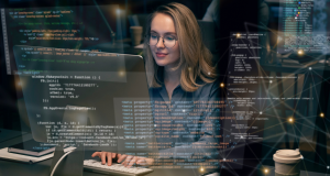 A young woman coding on a computer, learning programming skills through an online course.