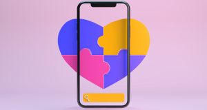Smartphone screen with a colorful heart made of puzzle pieces.