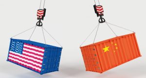 US and China flag shipping containers hanging from cranes illustrating 2025 tariff trade war.